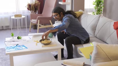 Man Reads And Studies Indoors at Home