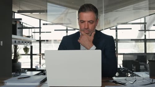 Busy Mature Business Man Ceo Looking at Laptop Thinking Analyzing Finance Data