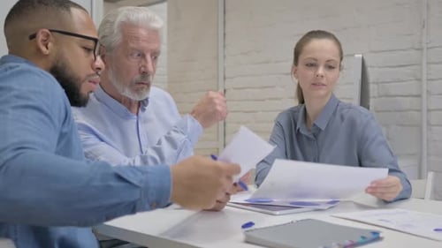 Mixed Race People Doing Paperwork in Office
