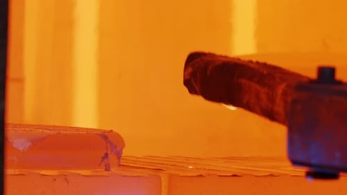 Metal parts inside an industrial furnace during forging process. Manufacturing of jet turbine parts