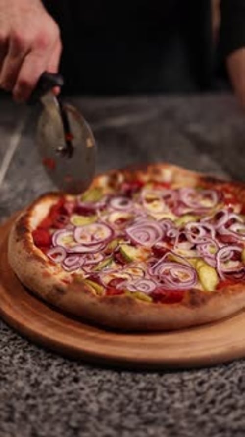 Fresh Pizza Being Sliced with Pizza Cutter
