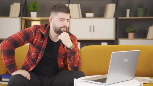Man Talks on Video Call from Couch