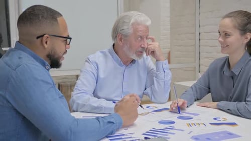 Diverse Team Analyzing Data in Modern Office