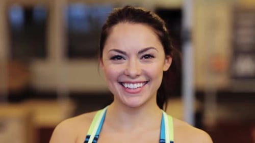 Smiling Woman in Workout Clothes at Gym