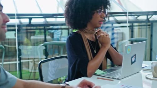 Team Meeting in Modern Office with Laptops