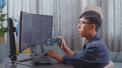 Asian Boy Programmer Using Smartphone While Creating Software Engineer Developing App, Program