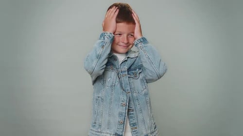 Boy Smiling and Making Hand Gestures in Studio