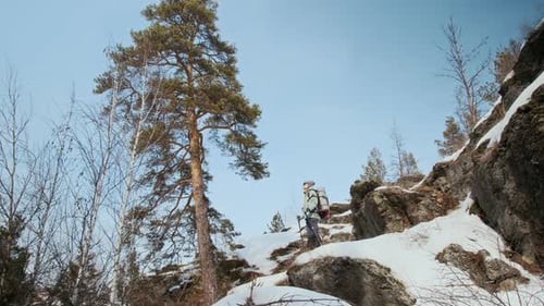 Hiker Walking on Rocky Mountains Standing Against Clear Sky