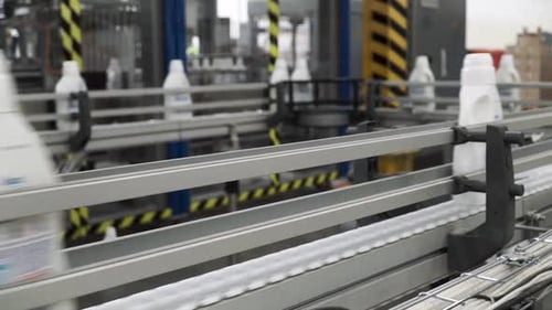 Plastic Bottles Moving on Industrial Conveyor Belt