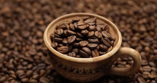 Roasted Coffee Beans in Decorative Cup Close Up