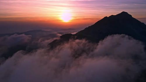 Timelapse view of clouds over the mountains at a wonderful sunset time from drone