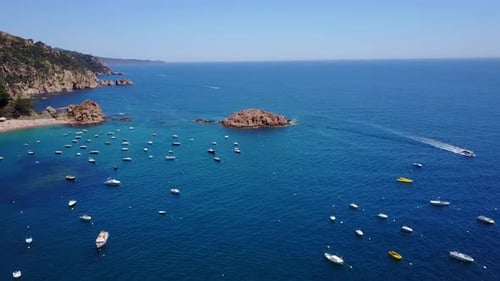 Flying above a port of yachts and boats, next to the coast of the Mediterranean Sea