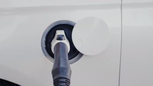 Charging a Car at Charging Station Concept Image of Electric Vehicle