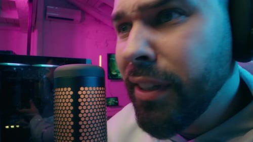 Man Talking Into Microphone With Headphones On