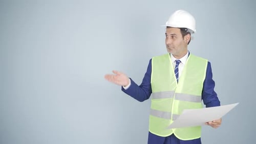 Man in Safety Vest Presents Building Plans