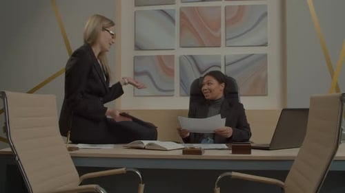 Lovely Diverse Multiethnic Female Colleagues Analyzing Company Finance at Office