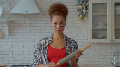 Woman with Rolling Pin in Kitchen