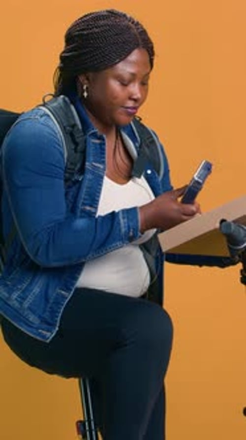 Woman Sitting Using a Smartphone in the Studio