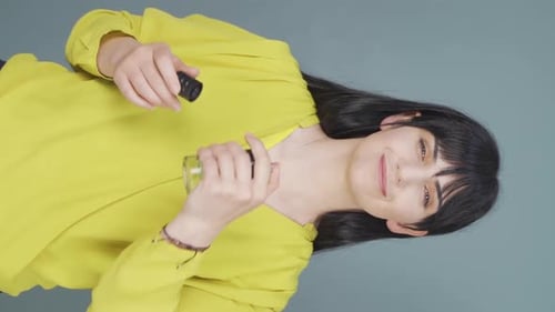 Woman Sprays and Smells a Bottle of Perfume