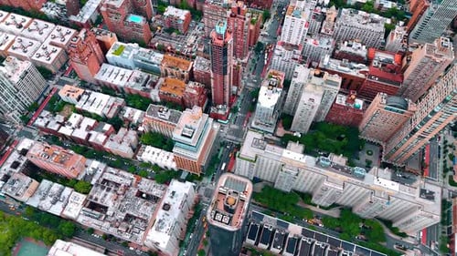 Footage over the tops of multi-storied buildings in the cityscape of lively city New York, USA.