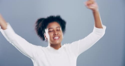 Woman Dancing Happily with Arms Raised Indoors