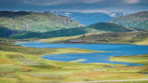 A timelapse video of heavy clouds rushing above the high-altitude plateau, casting dark shadows. Hig