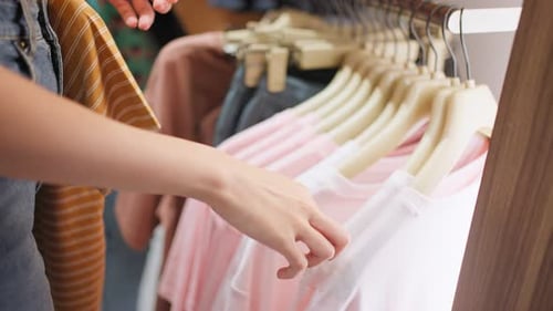 Close up of Asian young women look product of clothes in shopping mall.