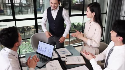 Business office colleagues celebrating collective achievement the successful completion of project w