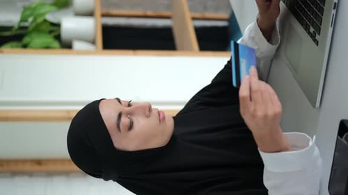 Woman with Laptop and Credit Card Shopping Online