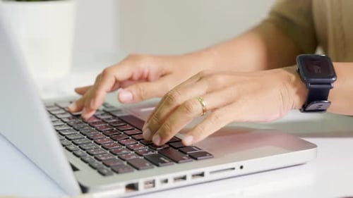 Close Up Hands of Business Woman Over Laptop Keypad During Working at Desk