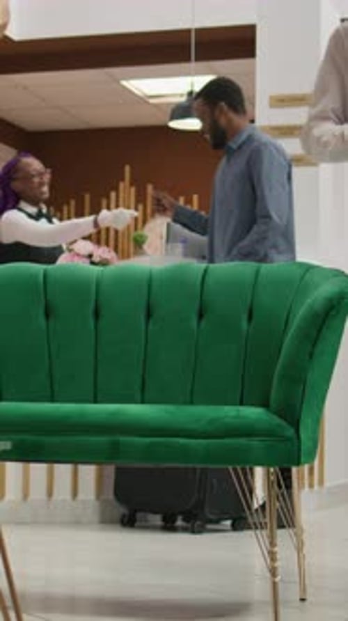 Hotel Reception Staff Helping Customers in Lobby