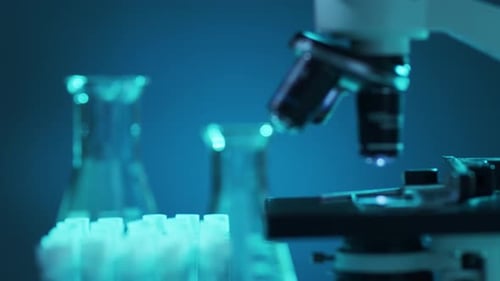 Microscope and Lab Equipment in Blue Lighting