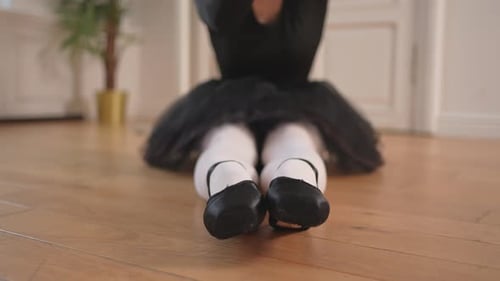 Ballerina Warming Up Stretches in a Dance Studio