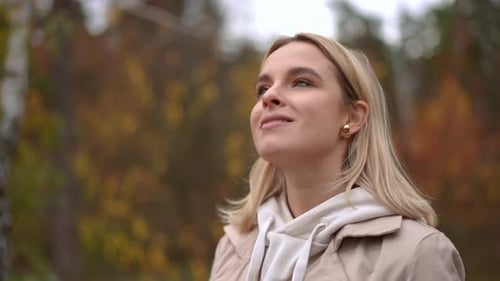 Woman Looking Up Outdoors in Autumn