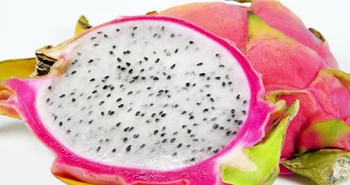 Close Up White Dragon Fruit Pulp Rotation Shot. Pitahaya Sliced Pieces Background
