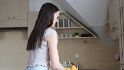 Woman Presents Bowl Full of Fresh Apricots
