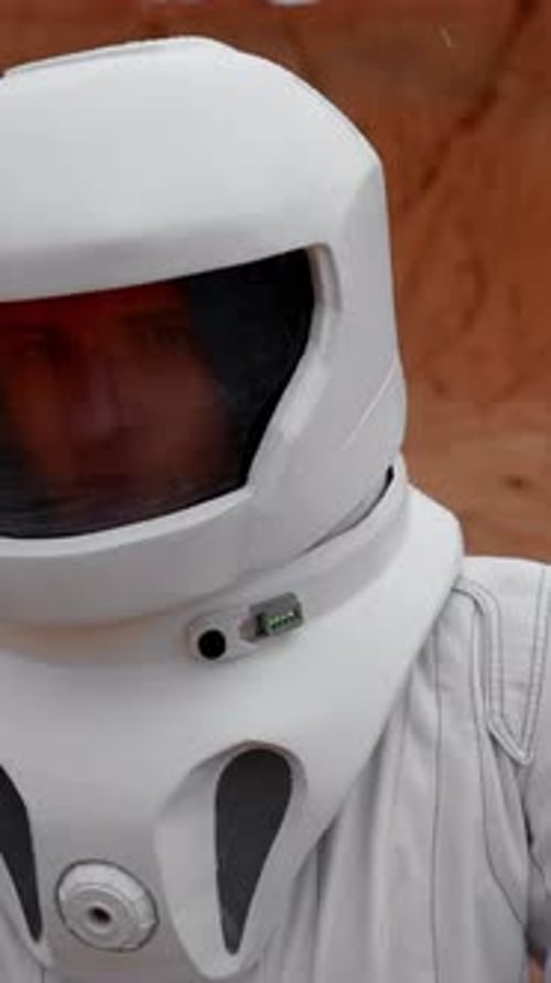 Vertical of Astronaut's Face in Cosmic Helmet Close Up in Unknown Planet's Crater
