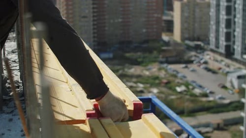 Construction Worker Assembling Wood Formwork On Building
