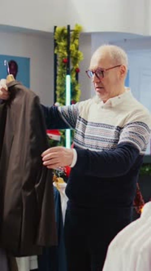 Older Man Browsing Clothing in Retail Store