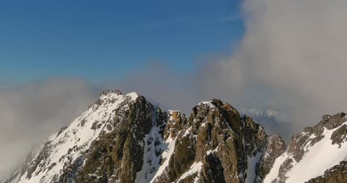Snowy Mountain Peaks With Rolling Clouds. British Columbia, Canada.