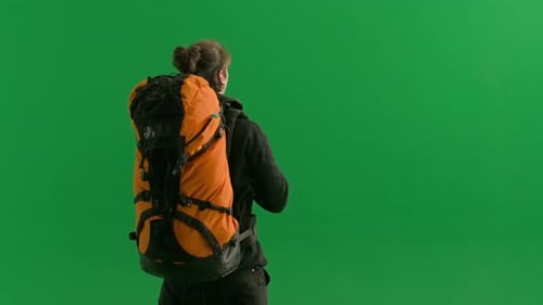 Back View of a Male Traveler Taking Photos on a Camera During a Hike A Male Traveler Stands in a