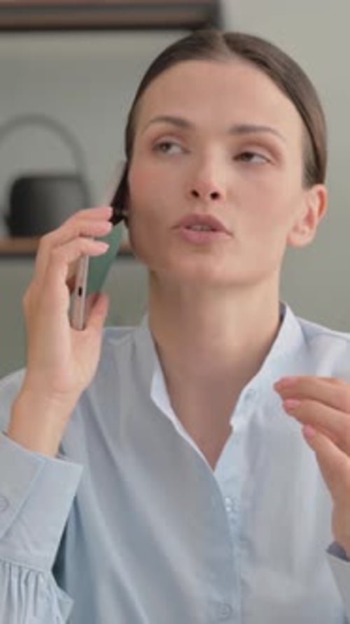 Woman Talking on Smartphone in Bright Room