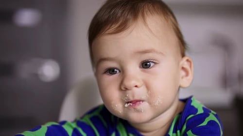 Baby Eats Food in the Kitchen