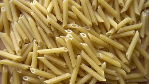Uncooked Penne Pasta Close Up Zoom Out