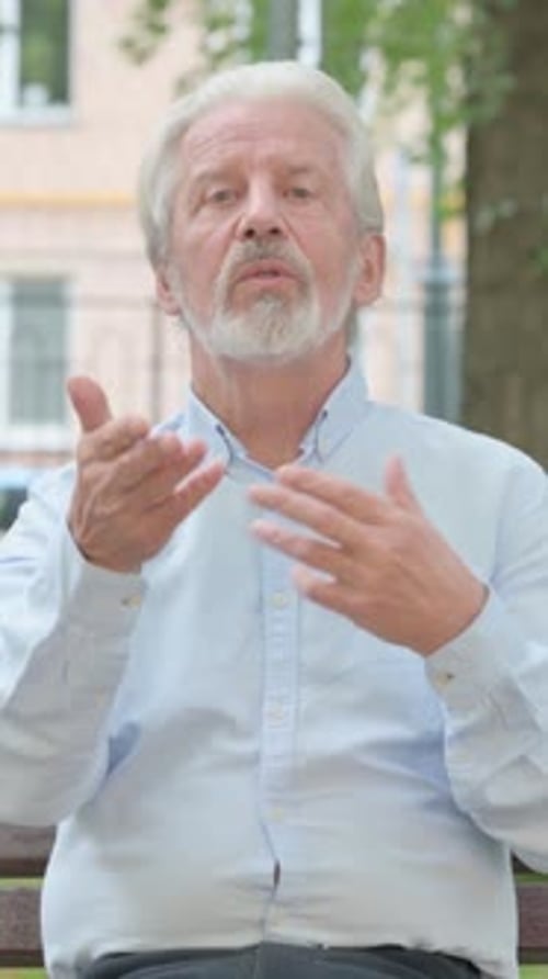 Talking Senior Old Man Blogging while Sitting in Park, vertical video