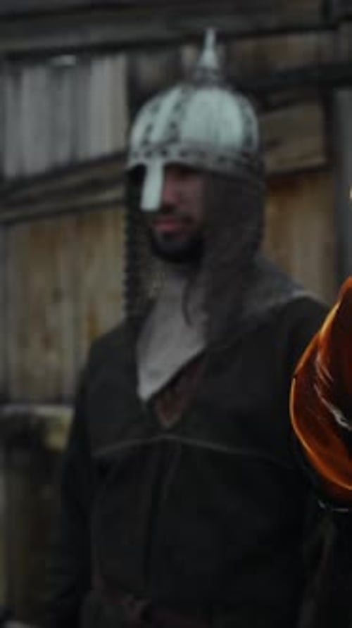 Guard with Flaming Torch Standing on Guard by Wooden Fortress Gate