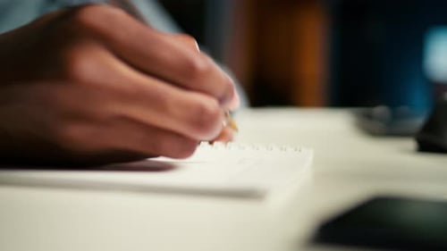 Hand Writes on Notepad in Close Up View
