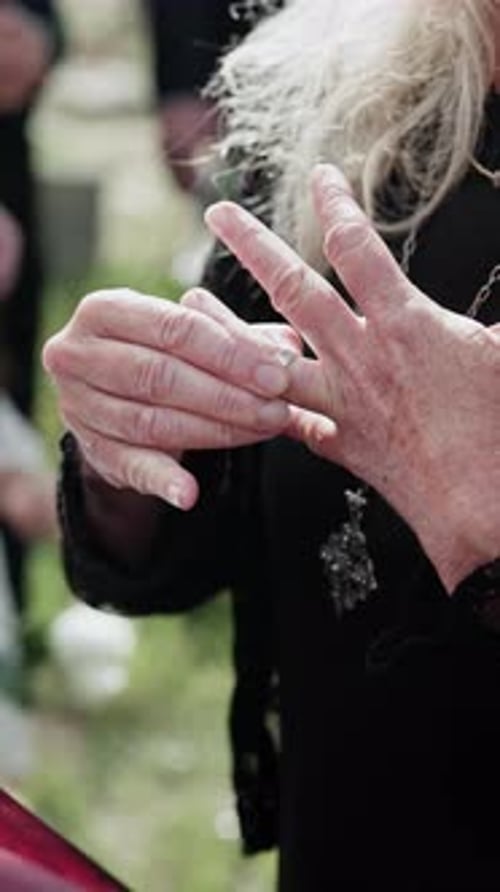 Elderly, hands or widow with ring on coffin for death, grief or condolences at funeral
