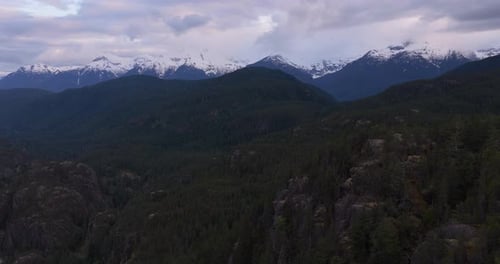 Aerial View of Snow-Capped Mountains and Lush Forests in British Columbia