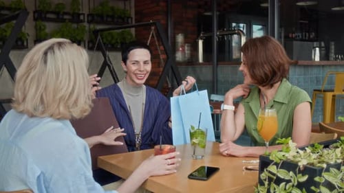 Three Women Spending Time in Cafe after Shopping